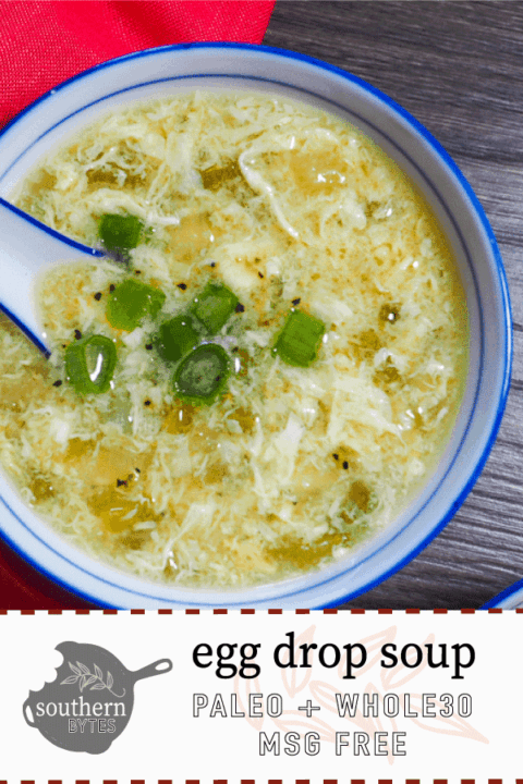 A pin image with one small bowl of paleo egg drop soup with a red napkin and ceramic spoon.