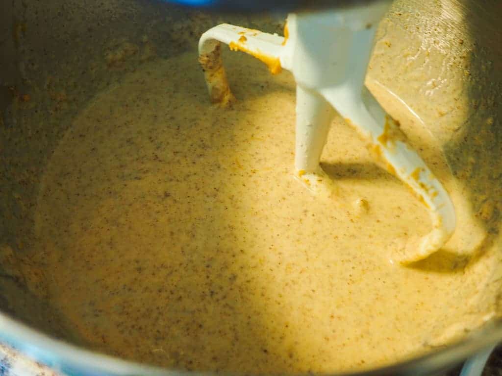 A mixing bowl with mashed banana, flax, peanut butter, and yogurt.
