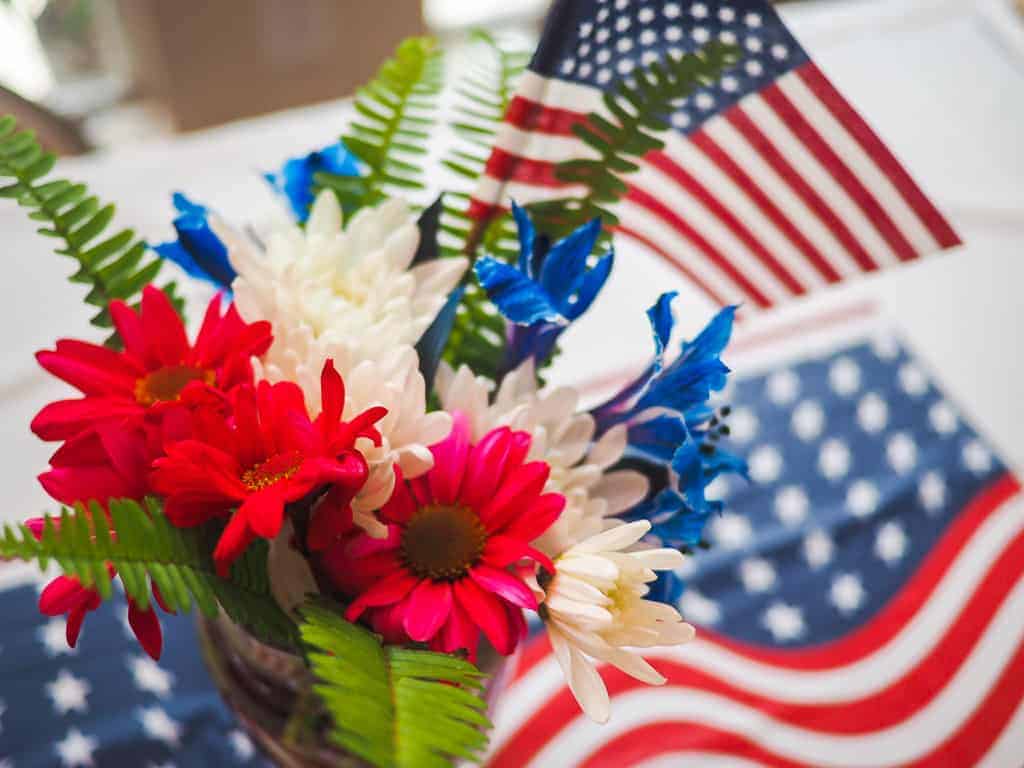 Red, white, and blue flowers and a small American flag.