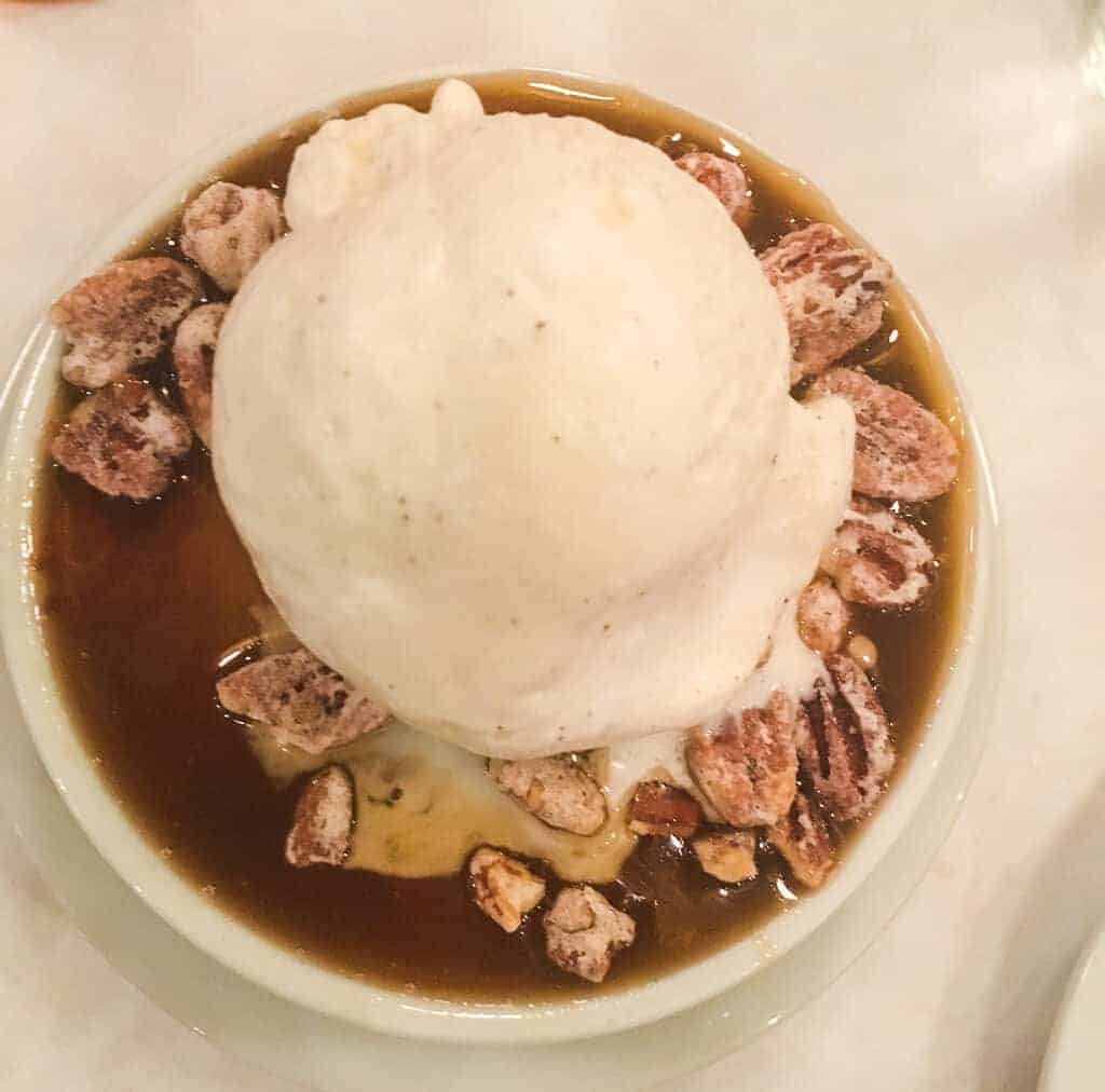 A bowl of bread pudding with ice cream on top from Luke Restaurant in New Orleans.