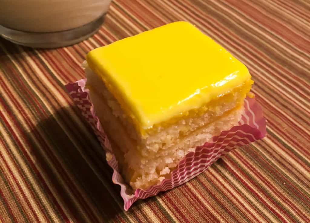 A square of lemon doberge cake.