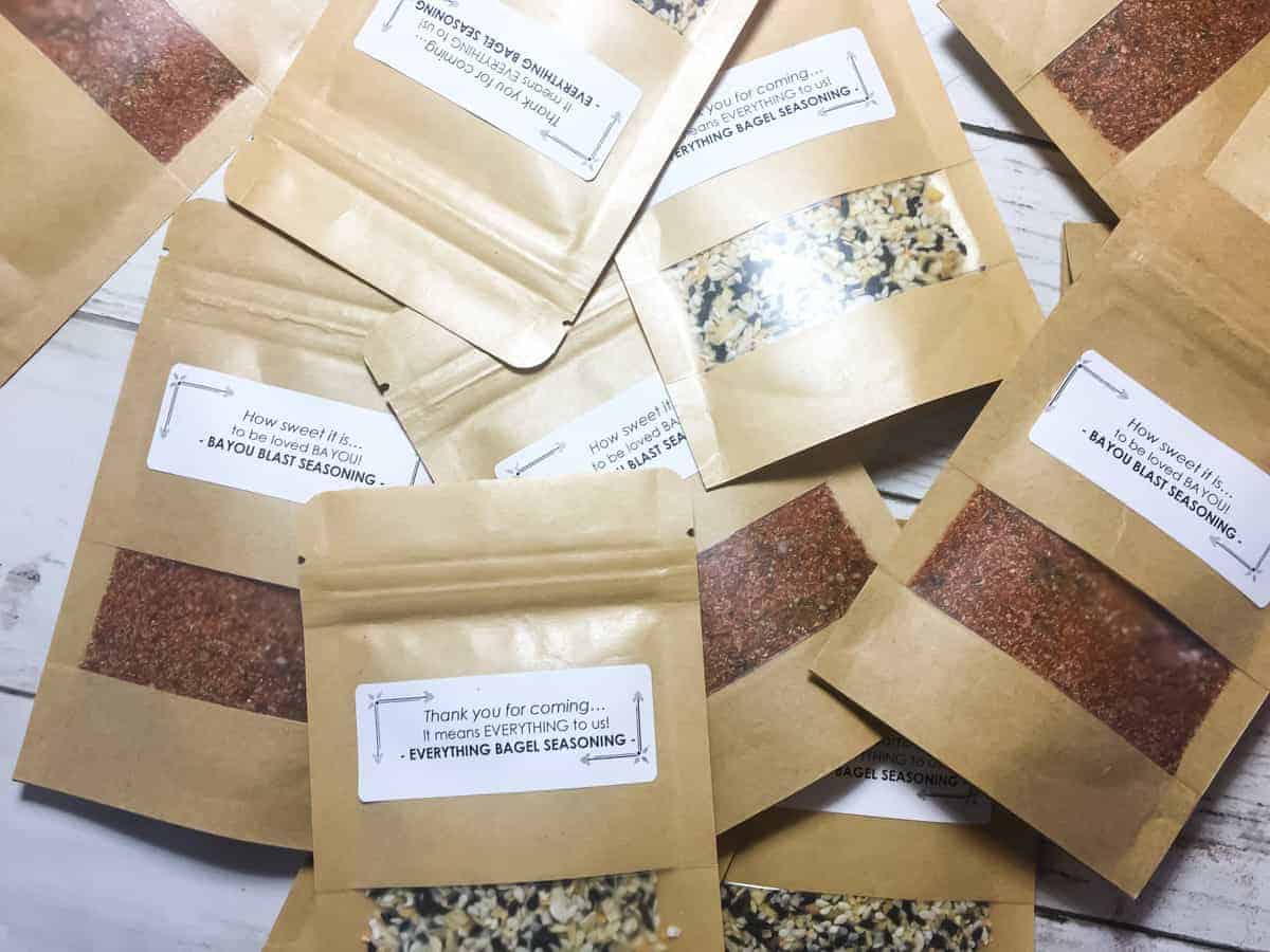 A pile of cajun seasoning and everything bagel seasoning mix packets used as a wedding favor.