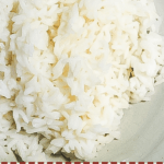 A pin image of a bowl of white rice cooked in an instant pot.
