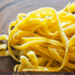 A pin image of a pile of paleo pasta cut into fettuccine on a wood cutting board.