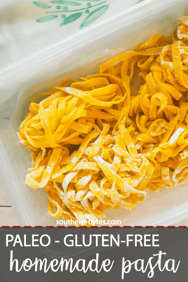 A pin image of a large clear tupperware filled with homemade paleo pasta and a tea towel with a turquoise pattern and a white wood board.