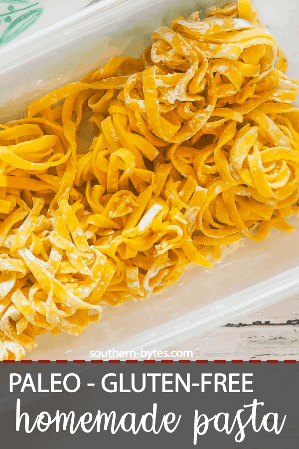 A pin image of a large clear tupperware filled with homemade paleo pasta and a tea towel with a turquoise pattern and a white wood board.