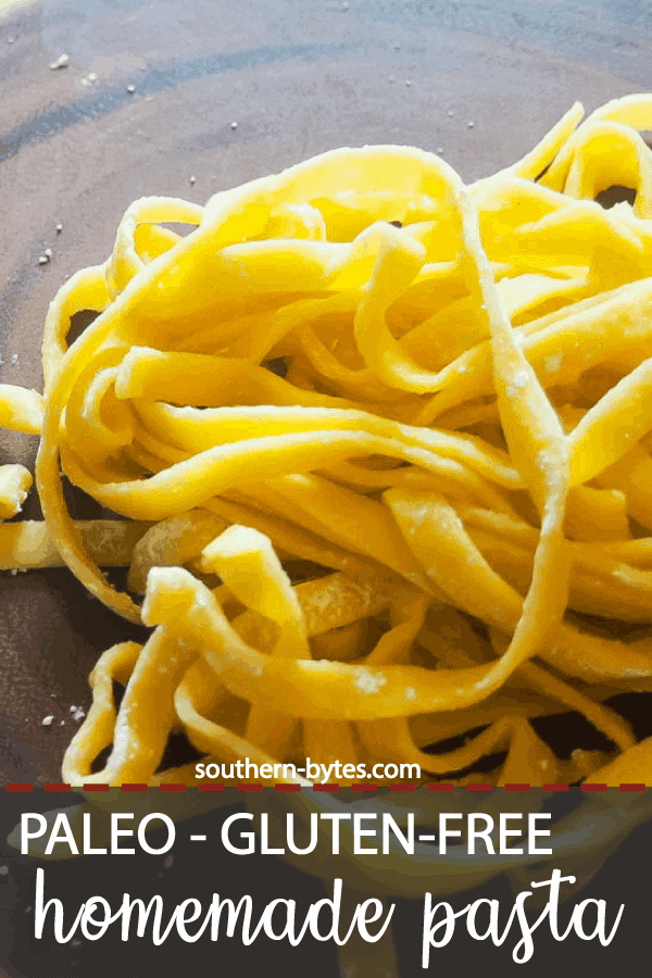 A pin image of a pile of paleo pasta cut into fettuccine on a wood cutting board.