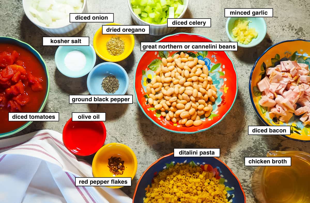 An image of pasta e fagioli ingredients in small bowls, labeled.