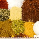 A pin image of the ingredients in taco seasoning in a bowl, unmixed.