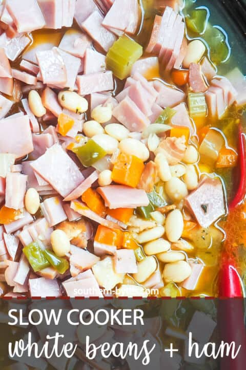 A pin image of a crockpot filled with white beans and ham, cooking.