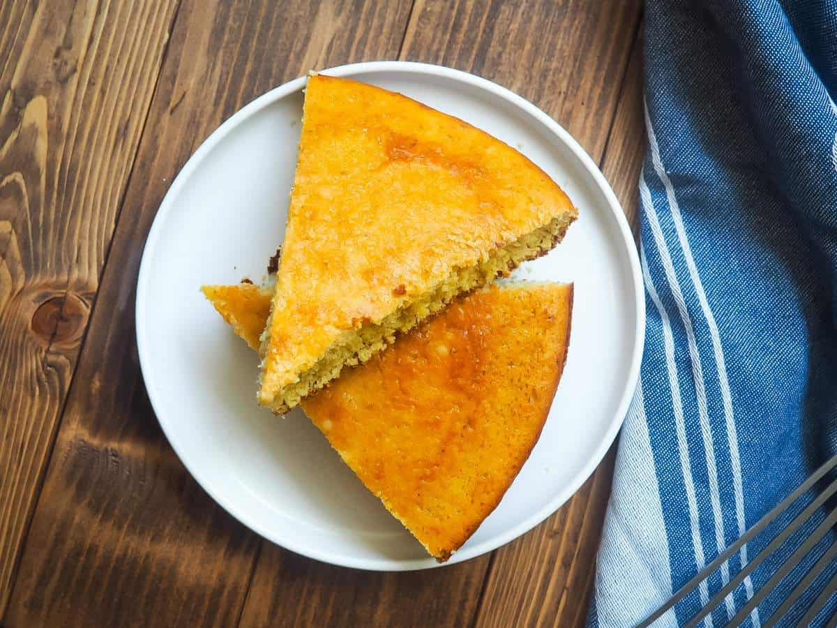 Slices of cornbread on a white plate.