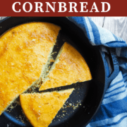 A pin image of a cast-iron skillet with slices of cornbread in it.