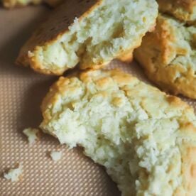 A zoomed in picture of drop biscuits on a non-stick baking mat.