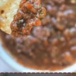 A pin image of a chip dipped in homemade salsa.