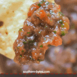 A pin image of a chip with homemade salsa on it.