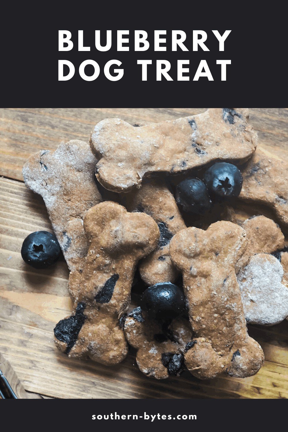 A pin image of a pile of blueberry dog treats and blueberries on a wooden background.