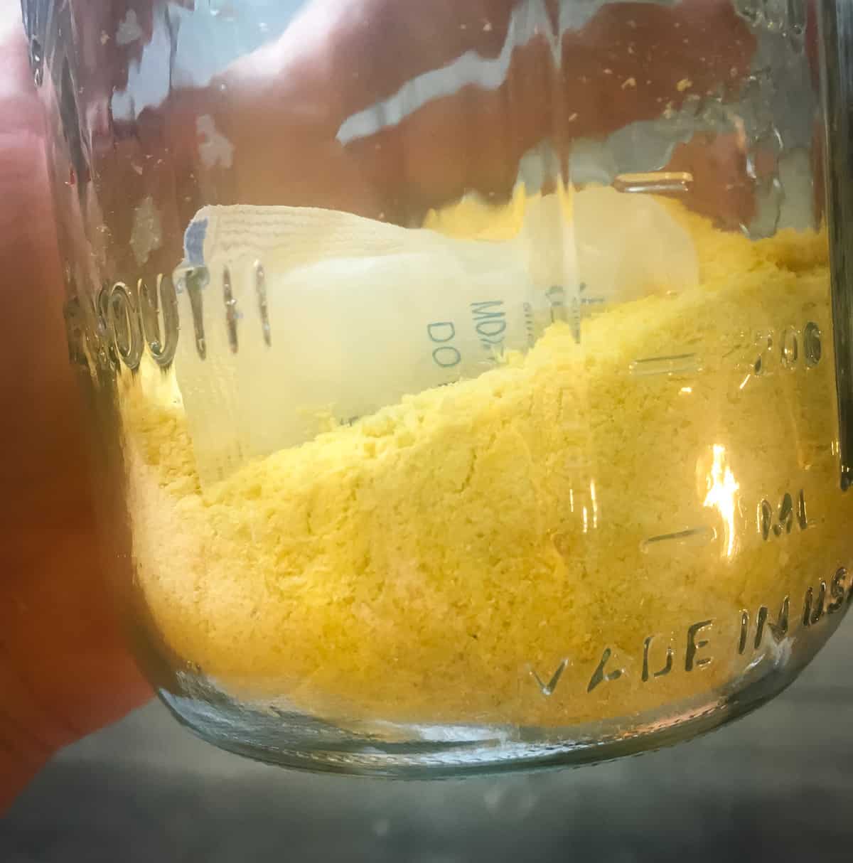 a jar of homemade cornmeal with a desiccant packet in it