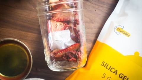 a spilled jar of dehydrated strawberries with a bag of desiccant packs