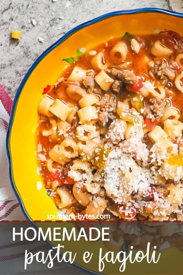 a pin image of a blue bowl of pasta e fagioli