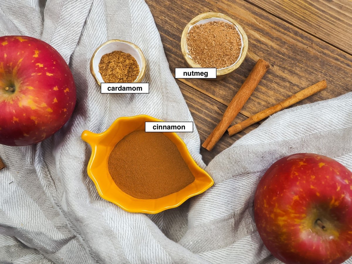 The ingredients in apple pie spice in bowls, labeled.