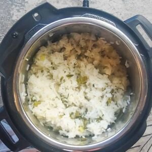 an instant pot with green onion rice in it