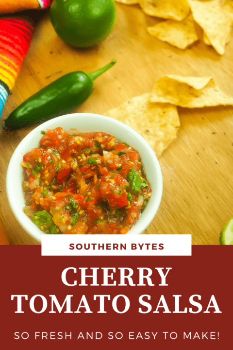 A pin image of a white bowl of cherry tomato salsa and some chips and a lime in the background.