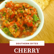 A pin image of a small white bowl of homemade salsa and some tortilla chips.