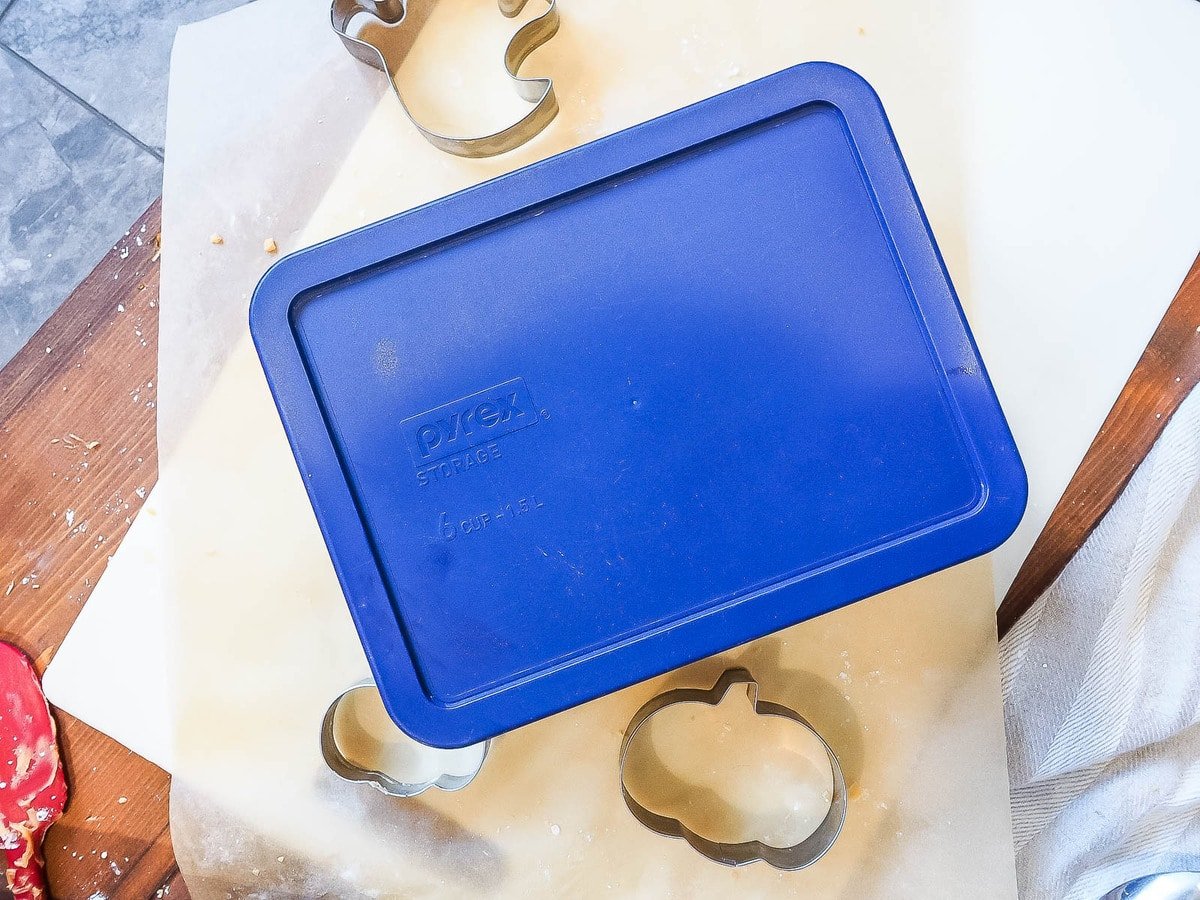 A blue glass pyrex container on top of brown parchment.