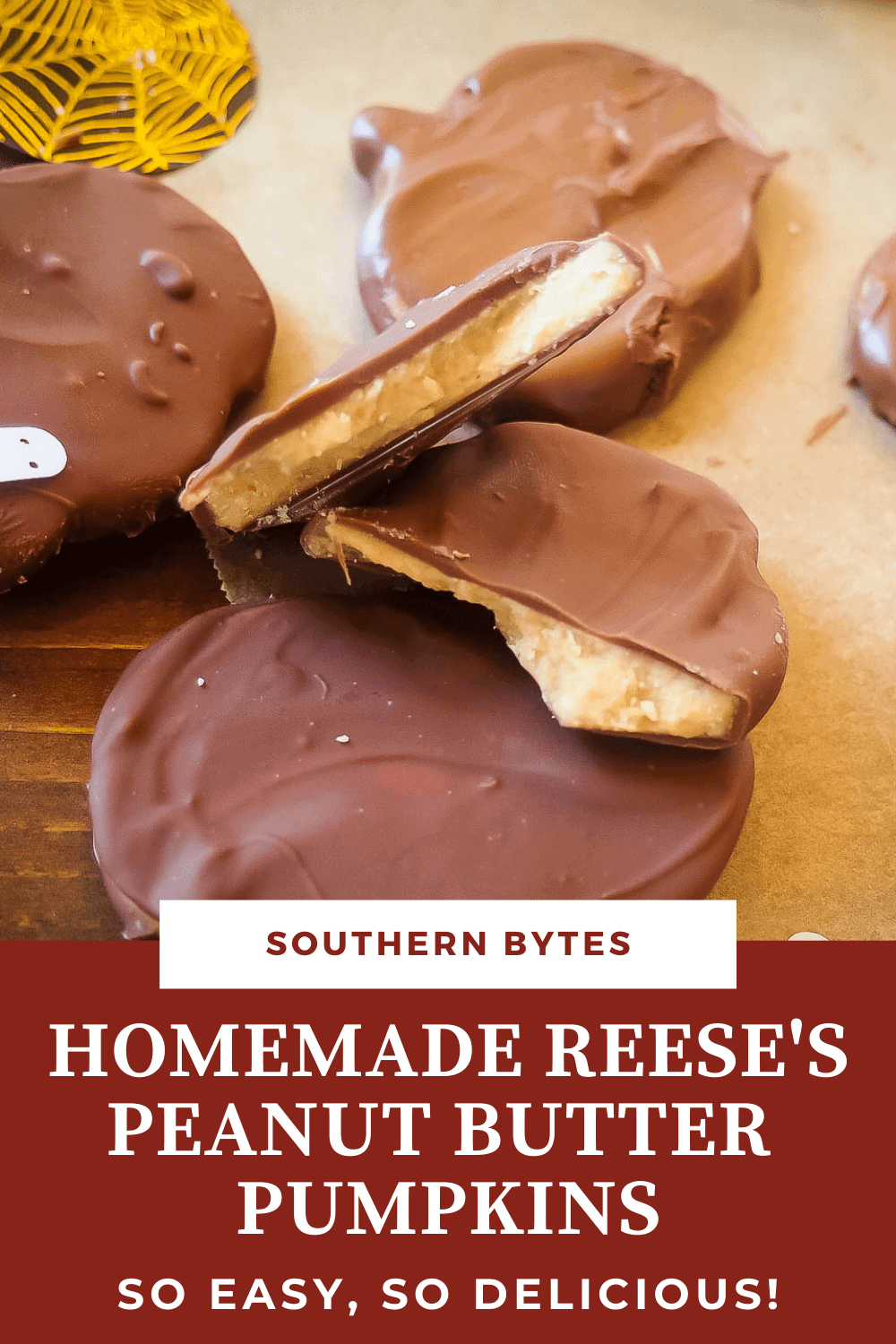 A pin image of a pile of homemade Reese's peanut butter cup pumpkins on brown parchment paper.