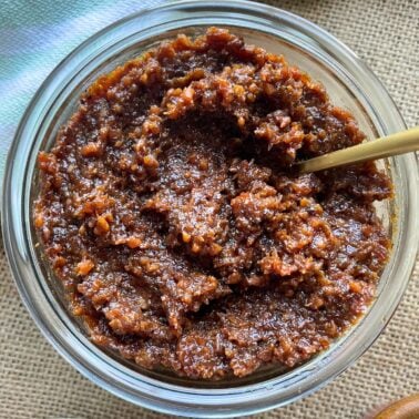 A zoomed in image of a small skillet filled with bacon onion jam.