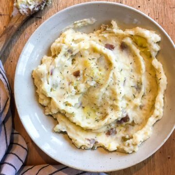 A bowl of cheesy garlic mashed potatoes.