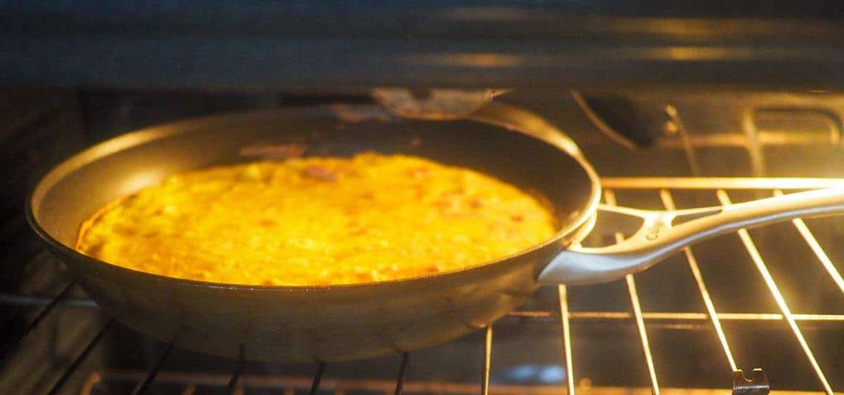 A frittata cooking in the oven.