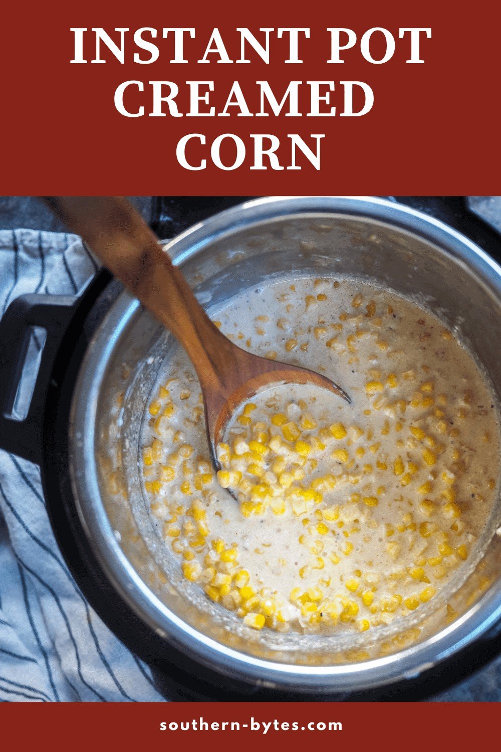 A pin image of a instant pot of creamed corn with a wooden spoon.