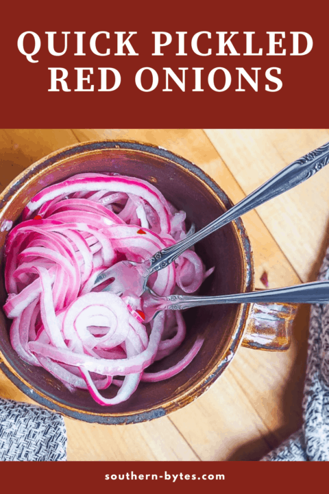 A pin image of a mug of pickled red onions with two forks twisted in them.
