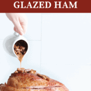 A pin image of a sliced ham with bourbon pecan glaze being poured over it.