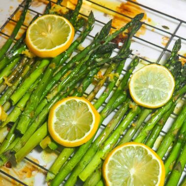 Cooked lemon asparagus on a cooling rack.