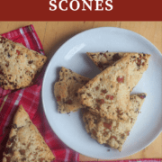 A pin image of a plate of ham and cheese scones with green onions.