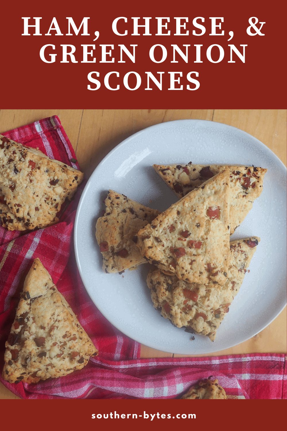 A pin image of a plate of ham and cheese scones with green onions.