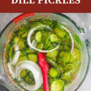 A pin image of a pyrex measuring cup with homemade pickles in it.