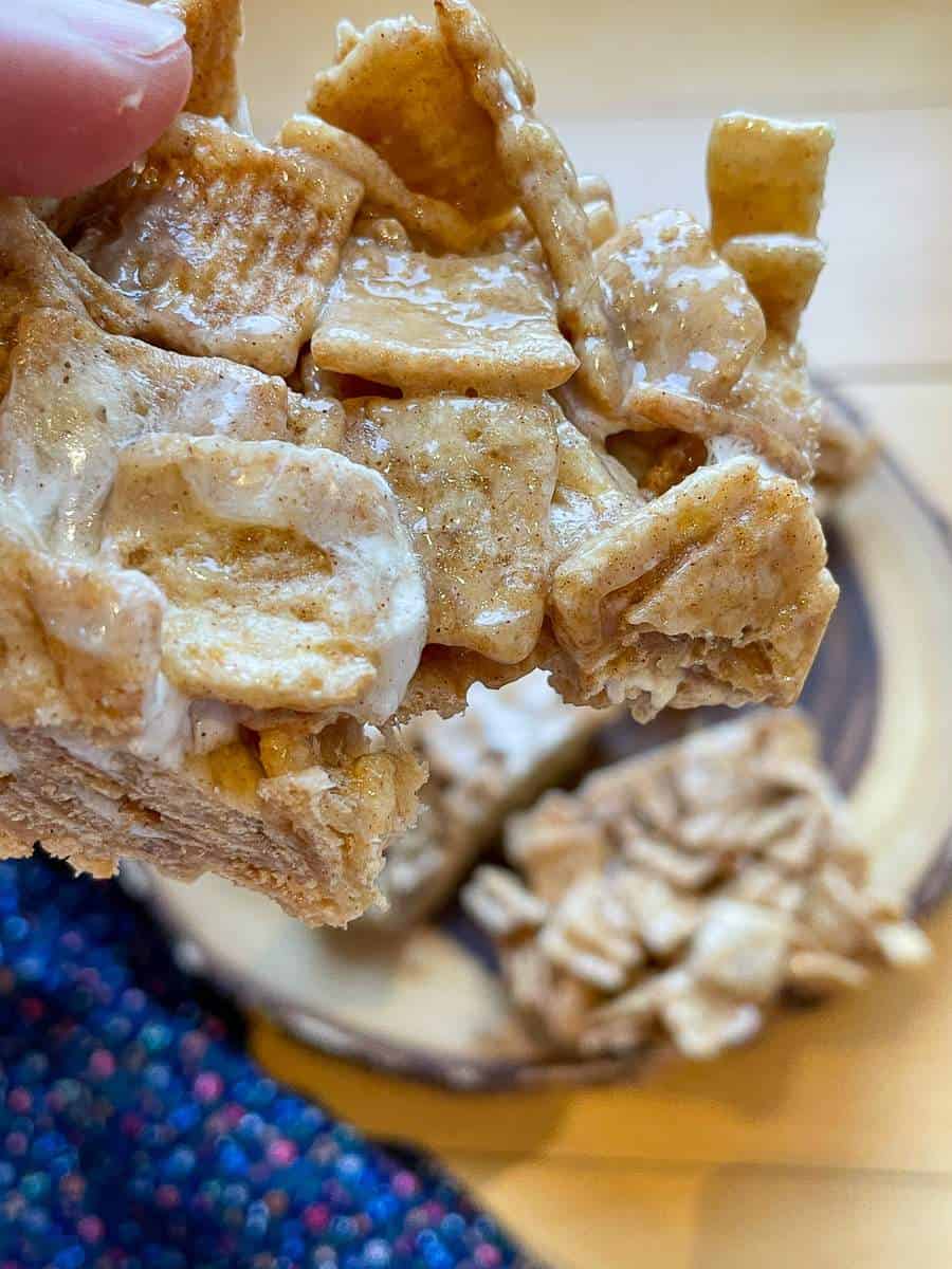 A Cinnamon Toast Crunch Cereal Treat with a bite taken out.