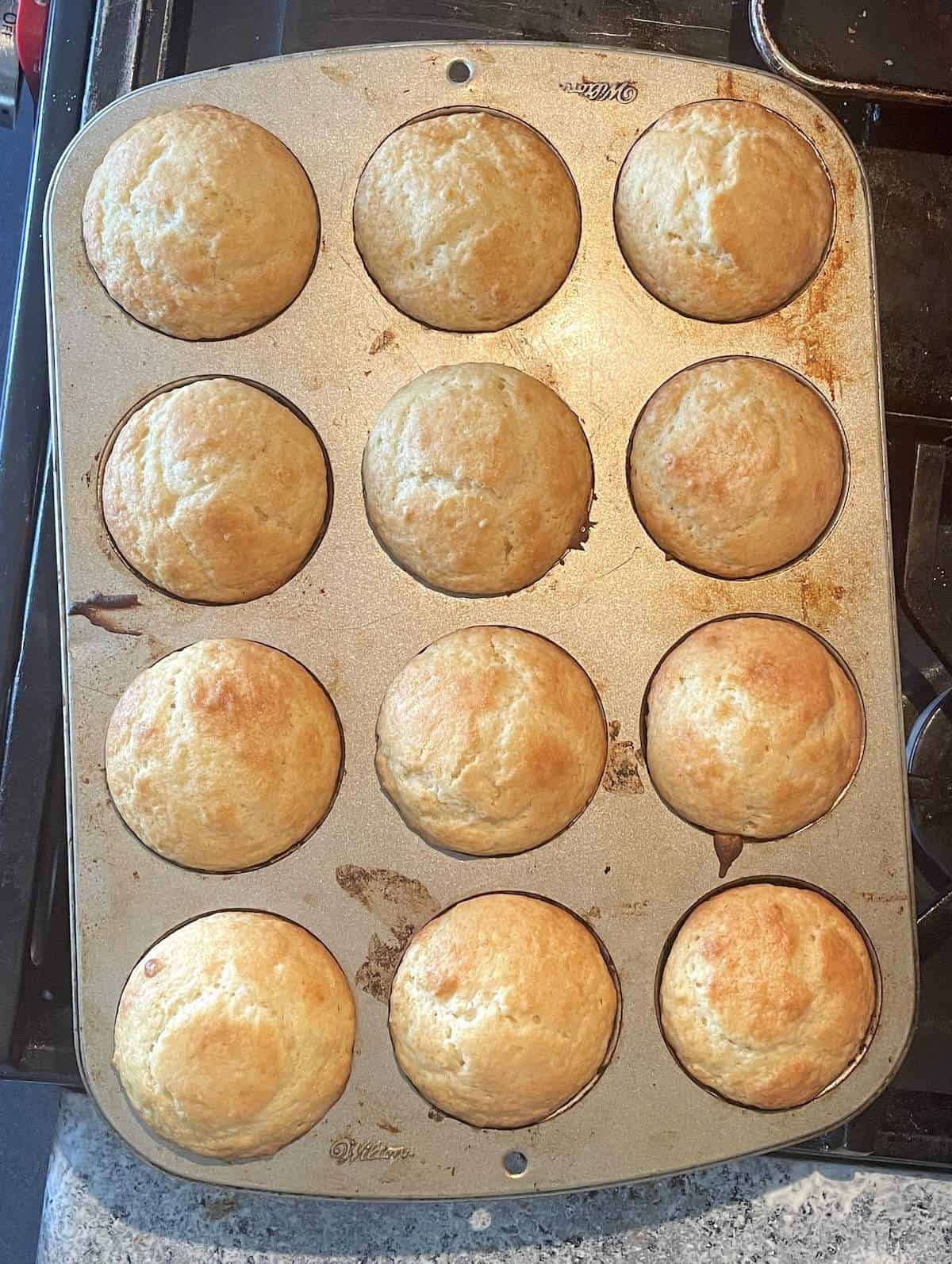 A pan of baked buttermilk muffins.