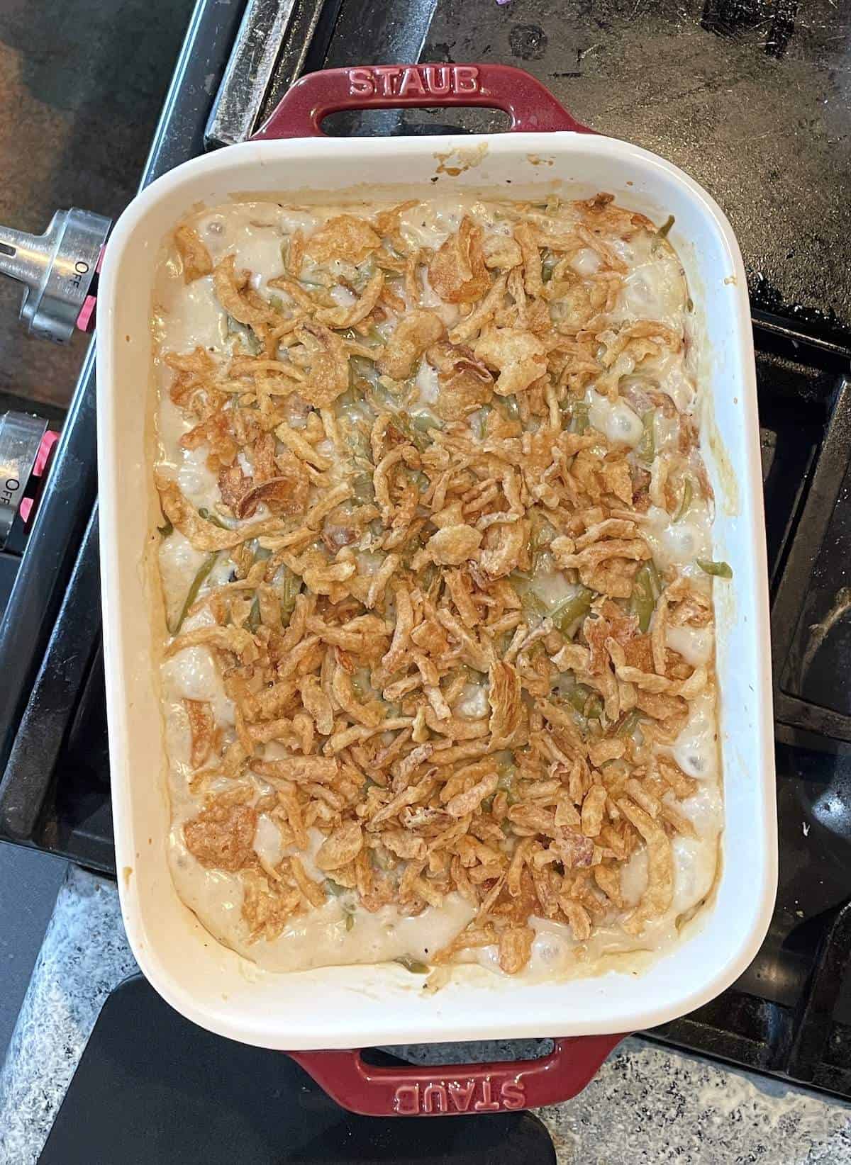 Classic French's green bean casserole covered in crispy onions in a baking dish fresh from the oven.