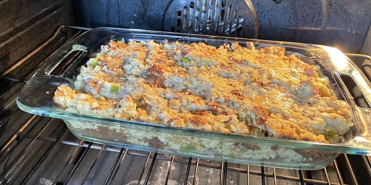 A pan of southern cornbread dressing baking in the oven.