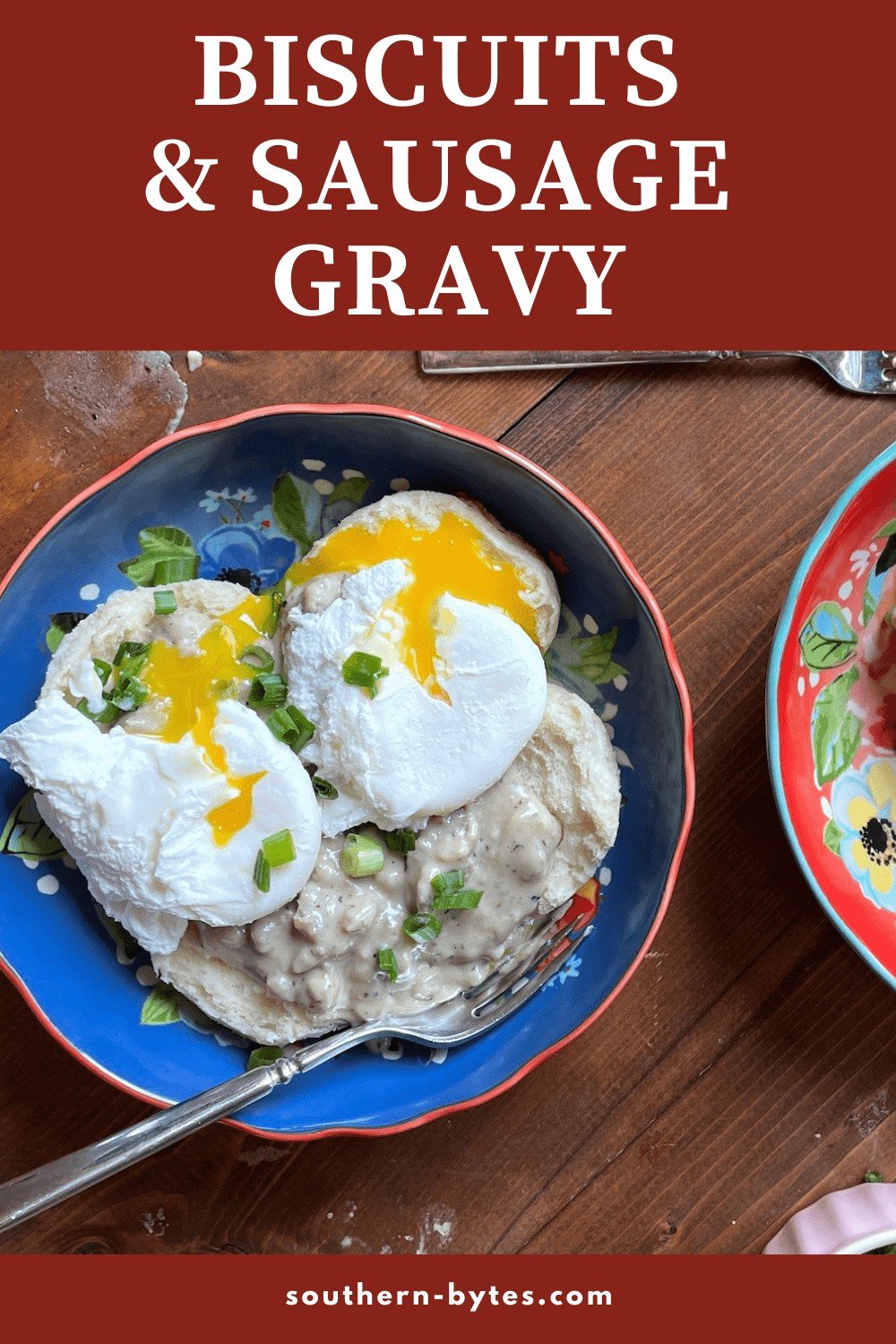 A pin image of a blue bowl with two biscuits topped with sausage gravy and two poached eggs.