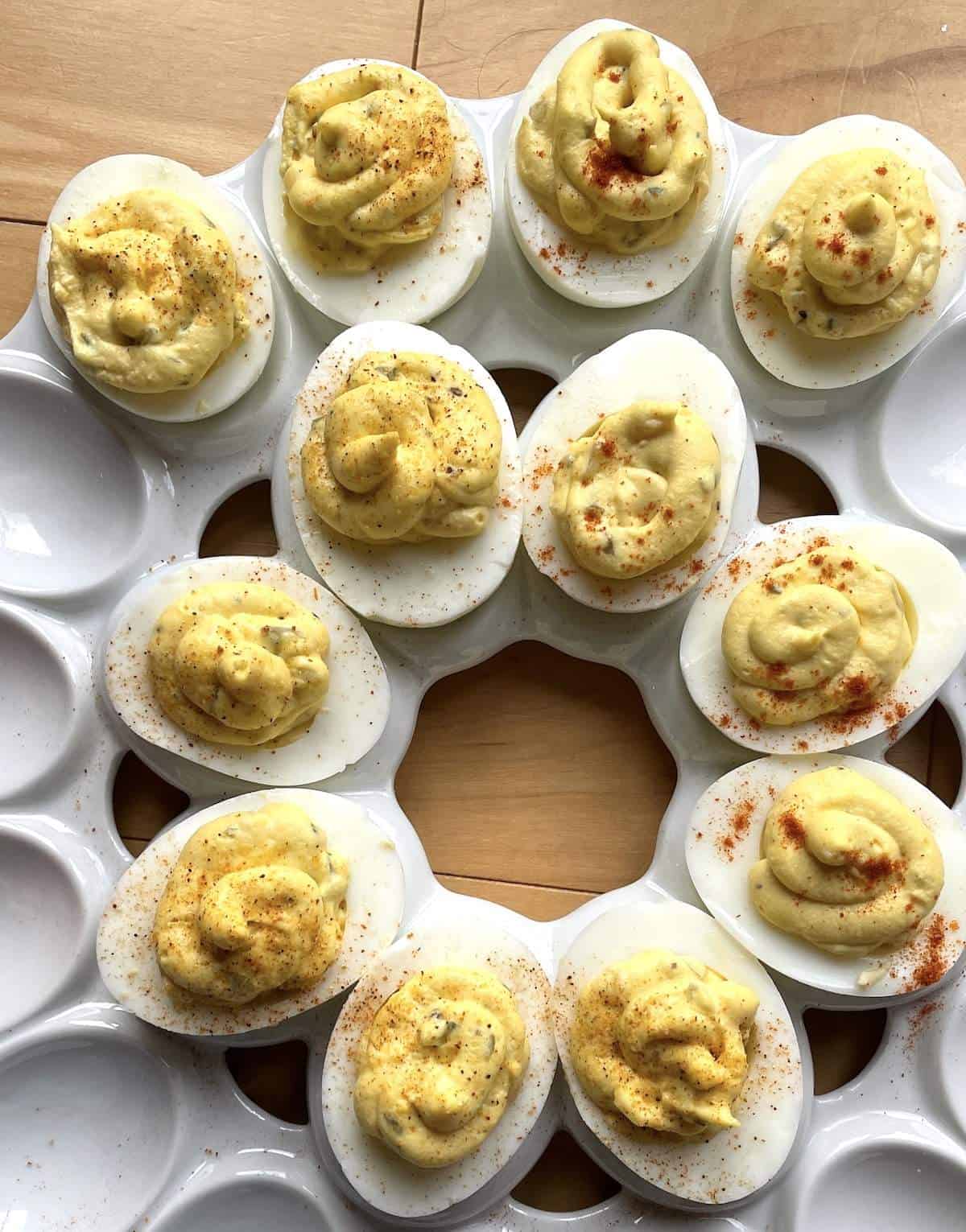 A circle of deviled eggs on a white platter.