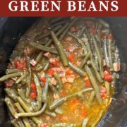 A pin image of southern green beans with ham cooking in a crockpot.