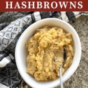 A pin image of slow cooker cheesy hash browns in a white bowl.