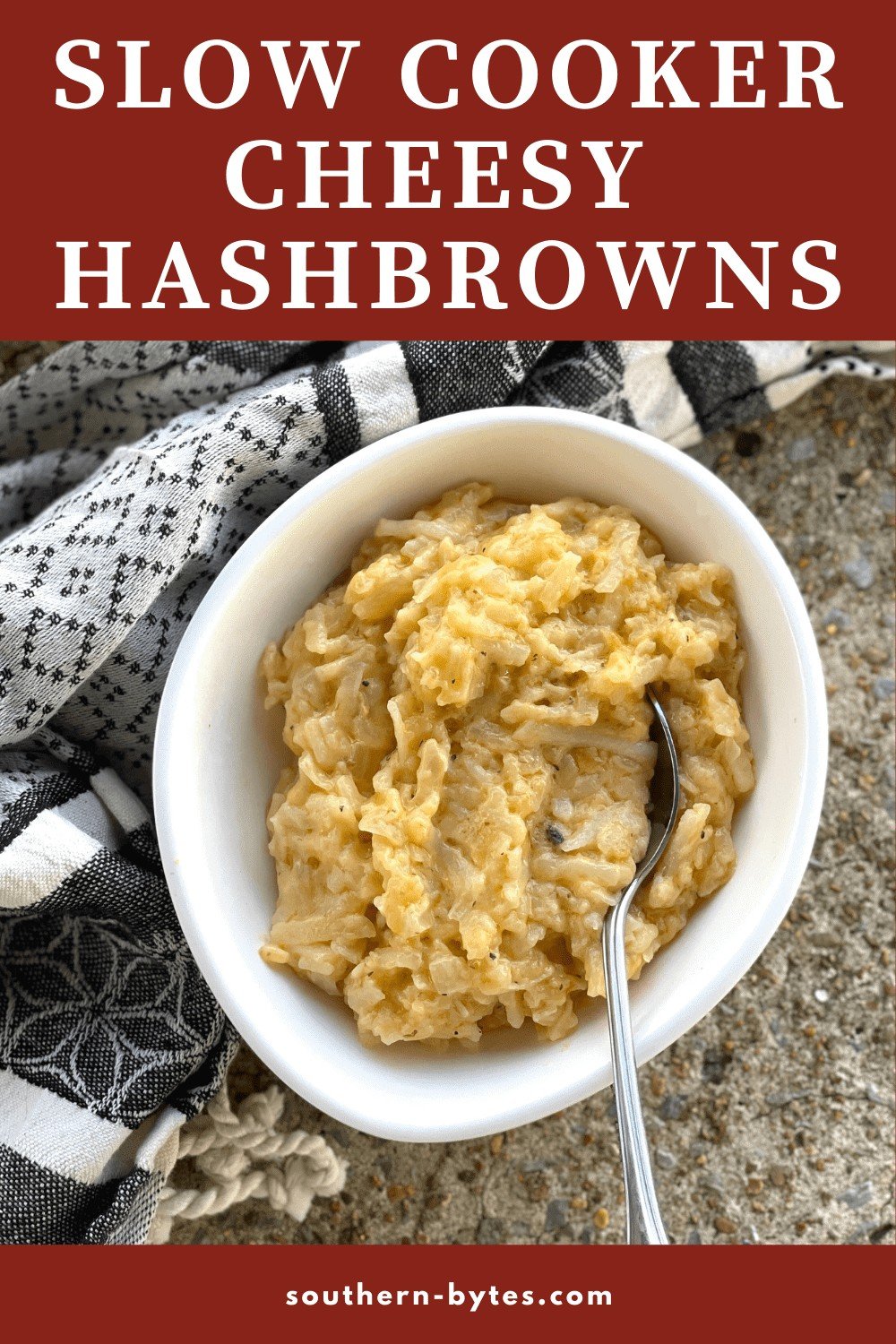 A pin image of slow cooker cheesy hash browns in a white bowl.