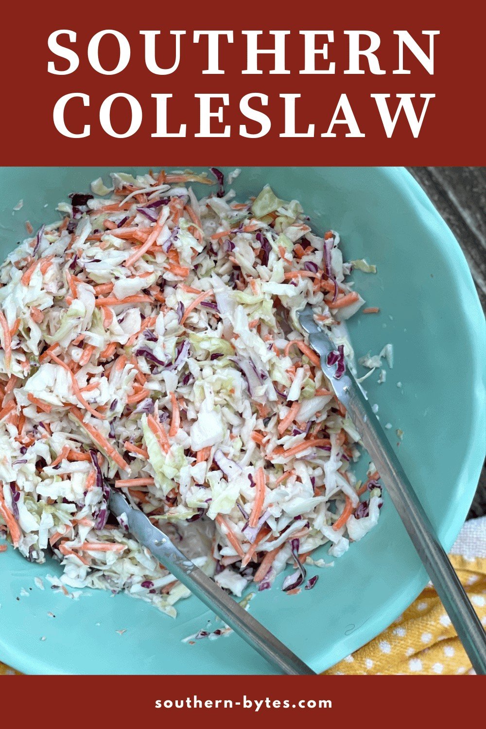 A pin image of a big blue bowl of creamy southern coleslaw with shredded carrots and a pair of tongs.