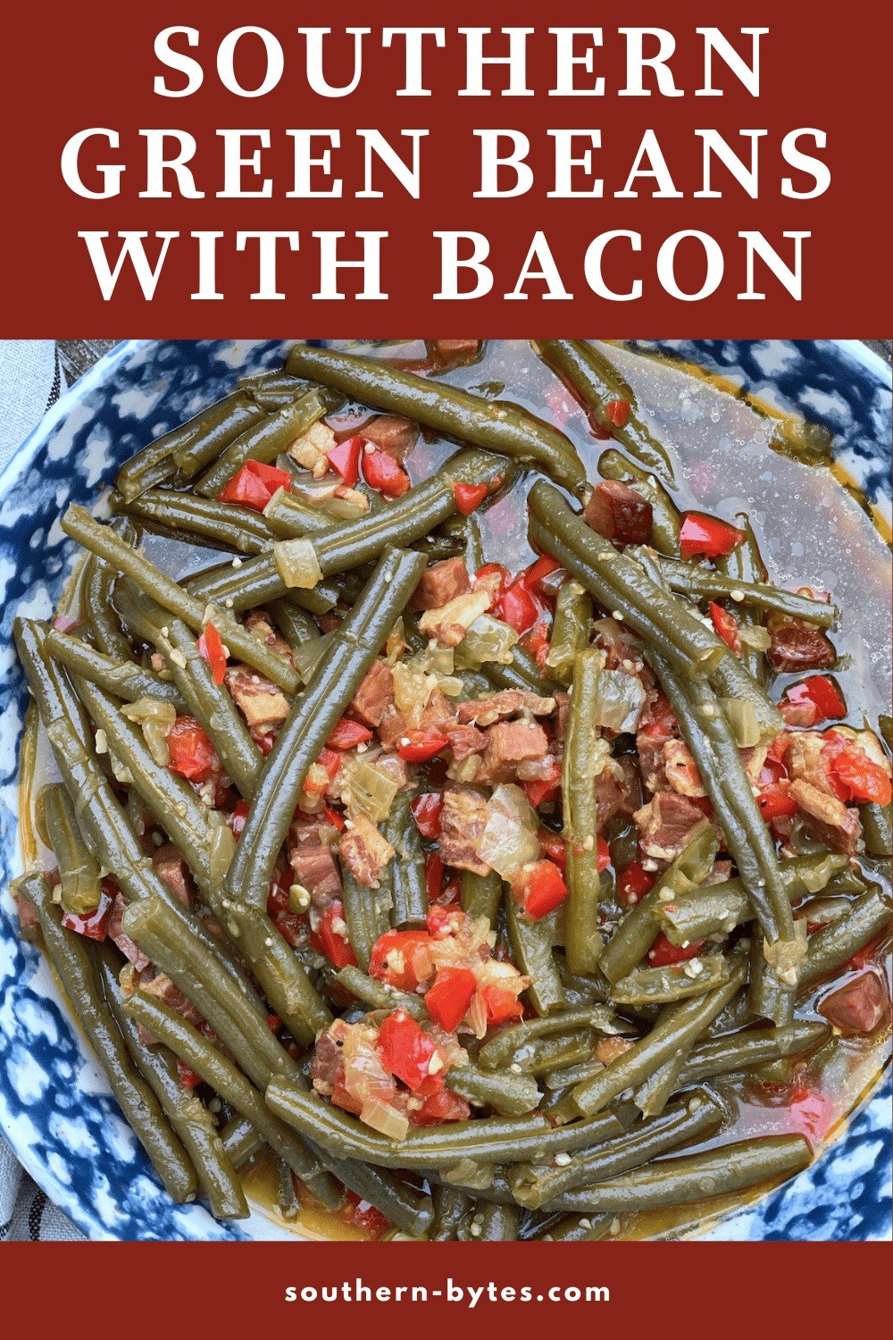 A pin image of a bowl of southern style green beans that were cooked in the crockpot with bacon and a ham hock.